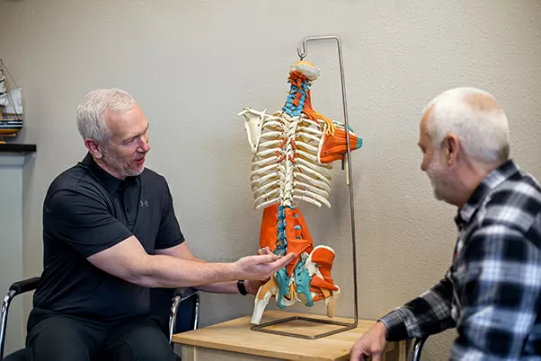 Chiropractor Lacey WA Dr Mitchell Derrick Showing Skeleton